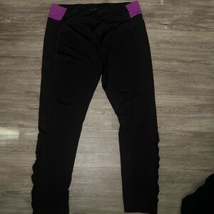 Black leggings with a spot of purple at the top
